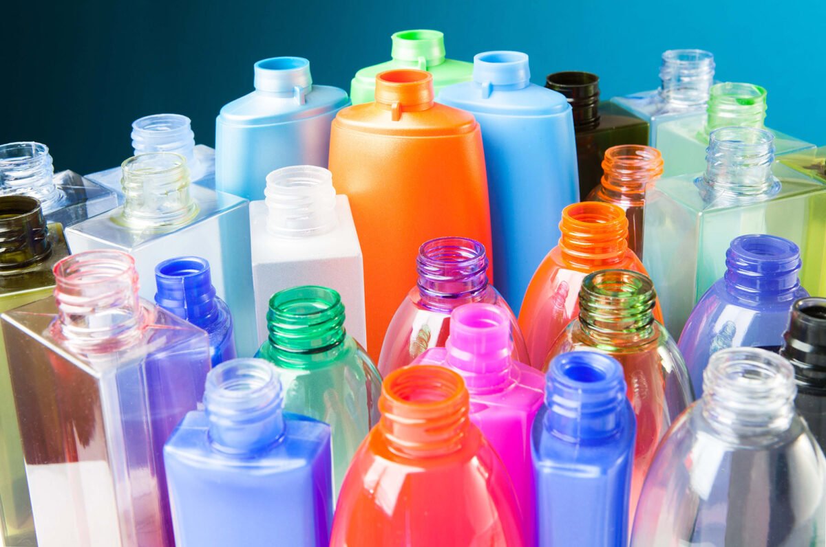 Several plastic bottles with both shiny reflective plastics, transparent plastics, and plastics that are less reflective.
