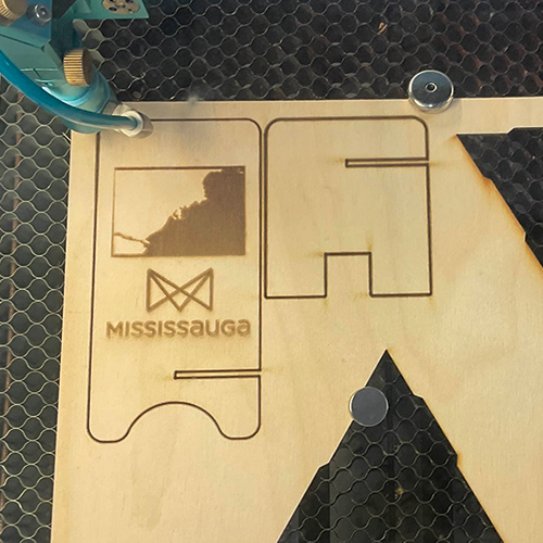 The first phone stand while it was being cut.